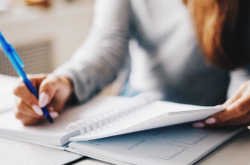 woman writing in planner