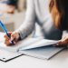 woman writing in planner