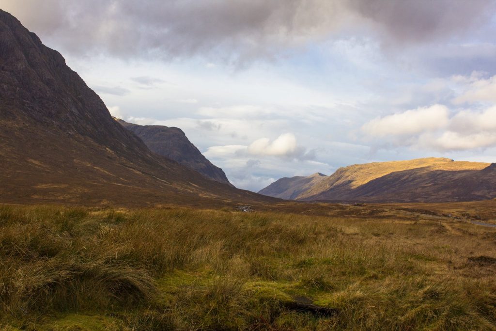 St. Andrews in Scotland, a valley with grasslands and mountains around it. 