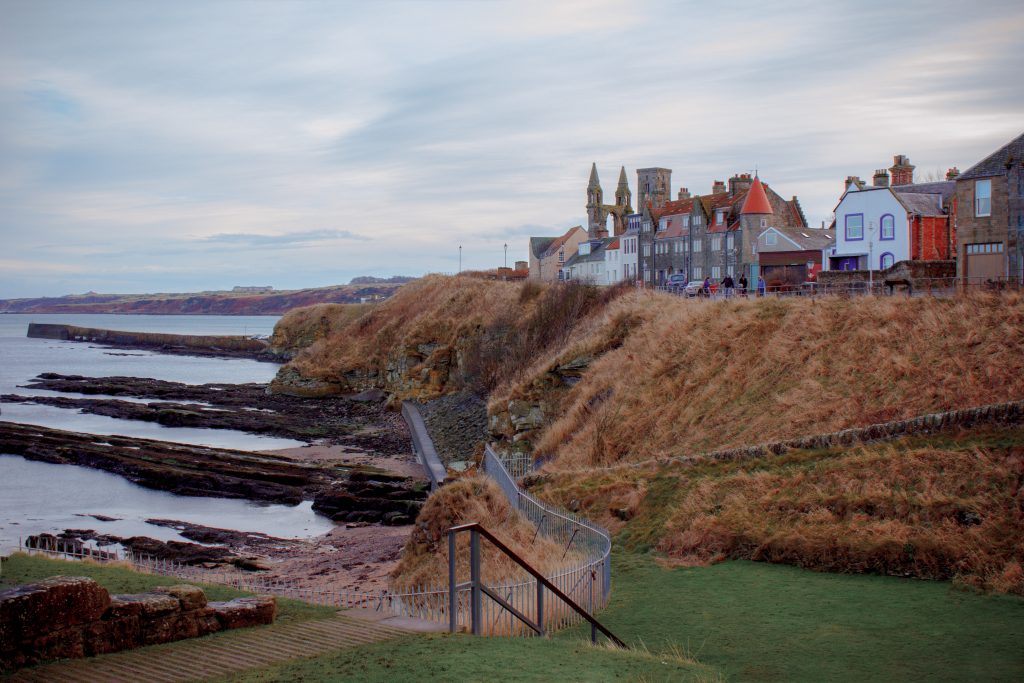 Scotland hillside with water and houses up on a hill