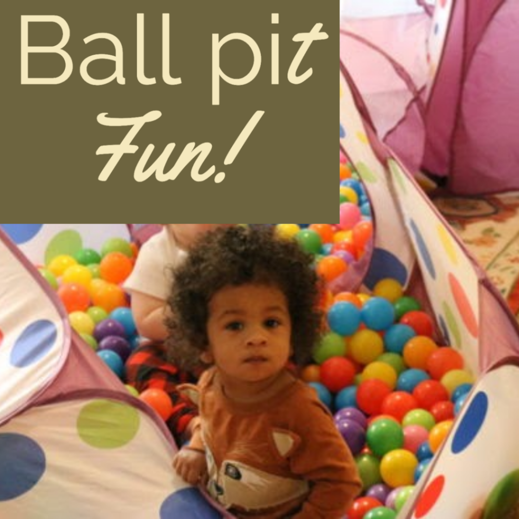 two young boys in a ball pit together at home