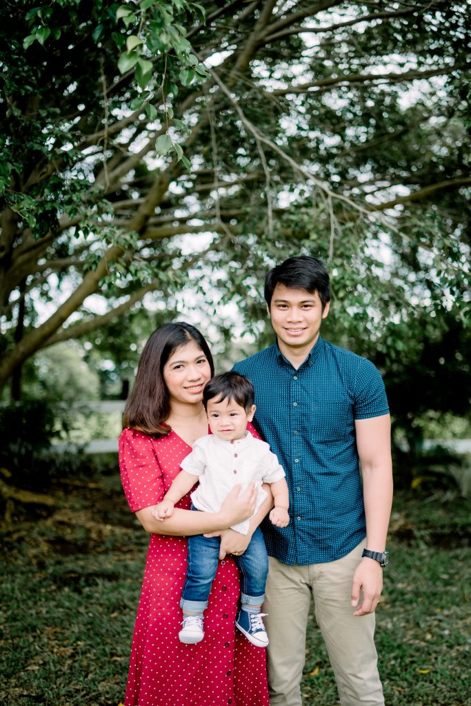 mom with son and husband photographed in park with trees