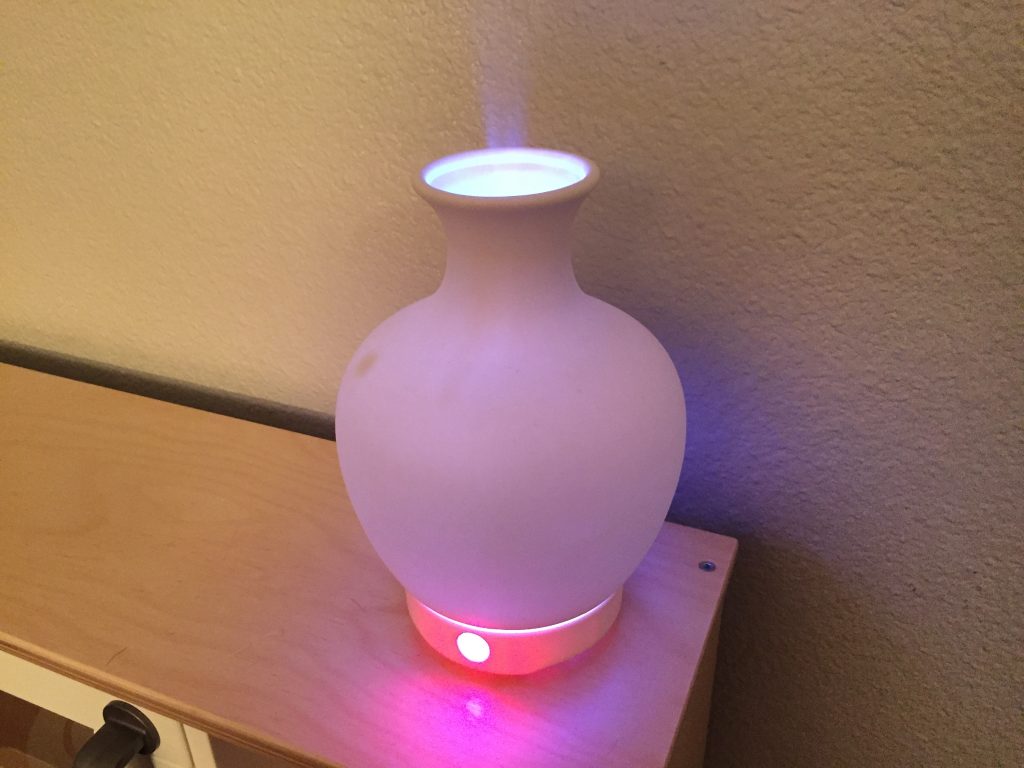 an electric essential oil diffuser on a shelf