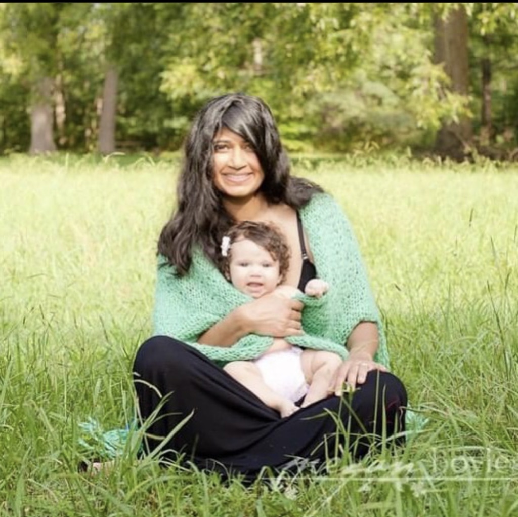 Mom celebrating world breastfeeding week in a meadow