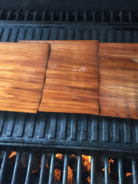 three cedar sheets on cast iron griddle for barbecue grill