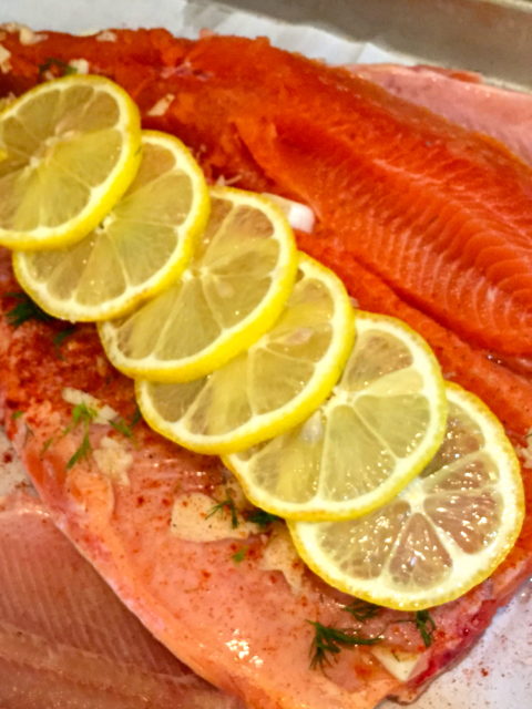 Cutthroat fillet with lemon, garlic, and dill ready for cooking