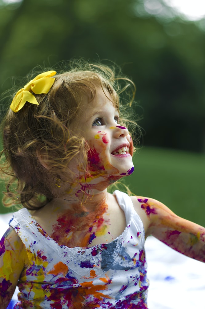 happy girl covered with paint and smiling