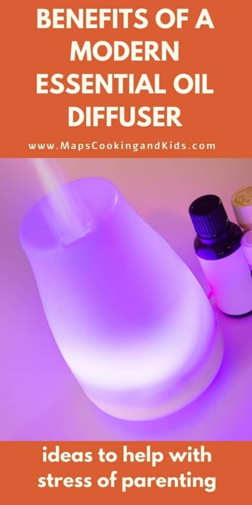 An essential oil diffuser lit up with a bottle of oil next to it