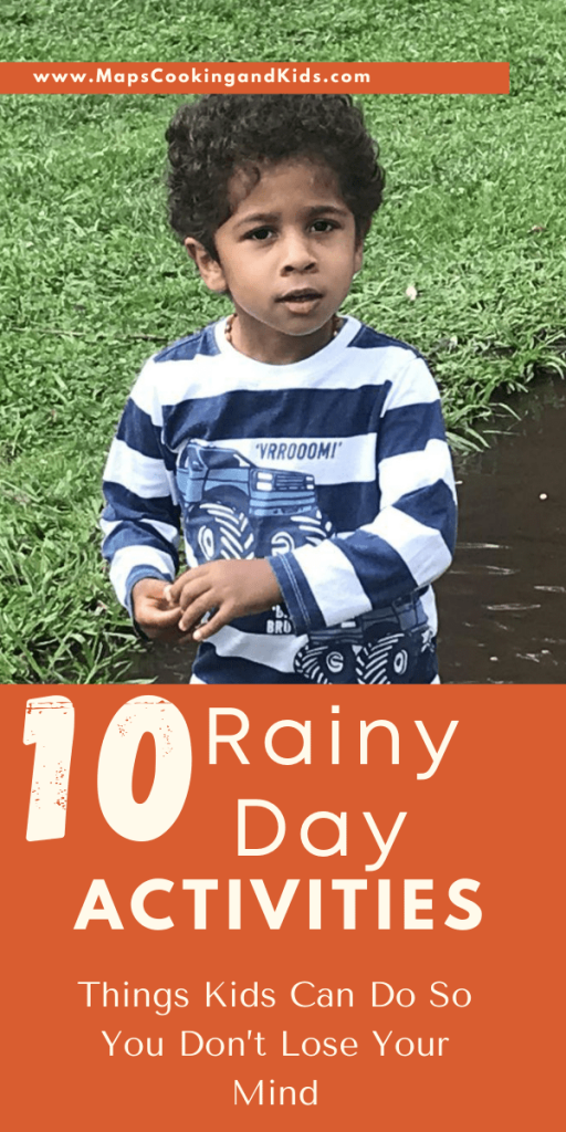 A toddler boy with rain boots in a puddle