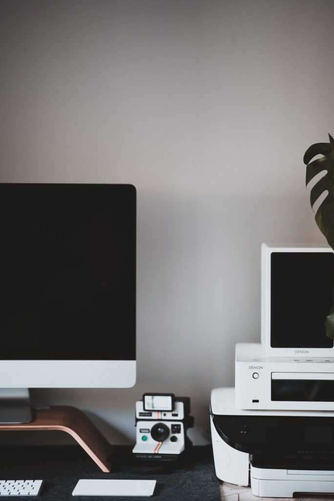 desktop computer on stand with polaroid camera, photo printer, and digital scanner