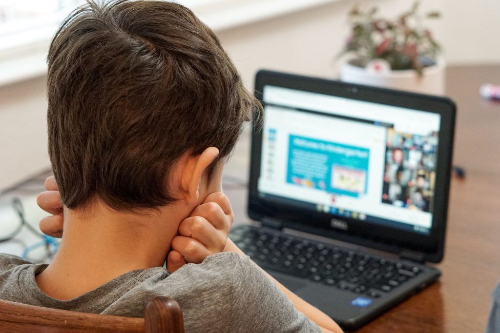 young boy looking at computer screen