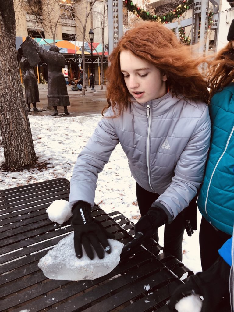 playing in the snow with toys