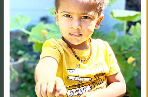 toddler in yellow shirt pointing his finger