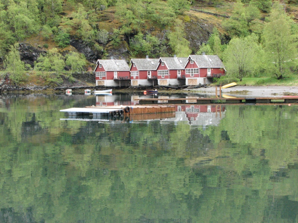 red house with boats on fjord in flam Norway