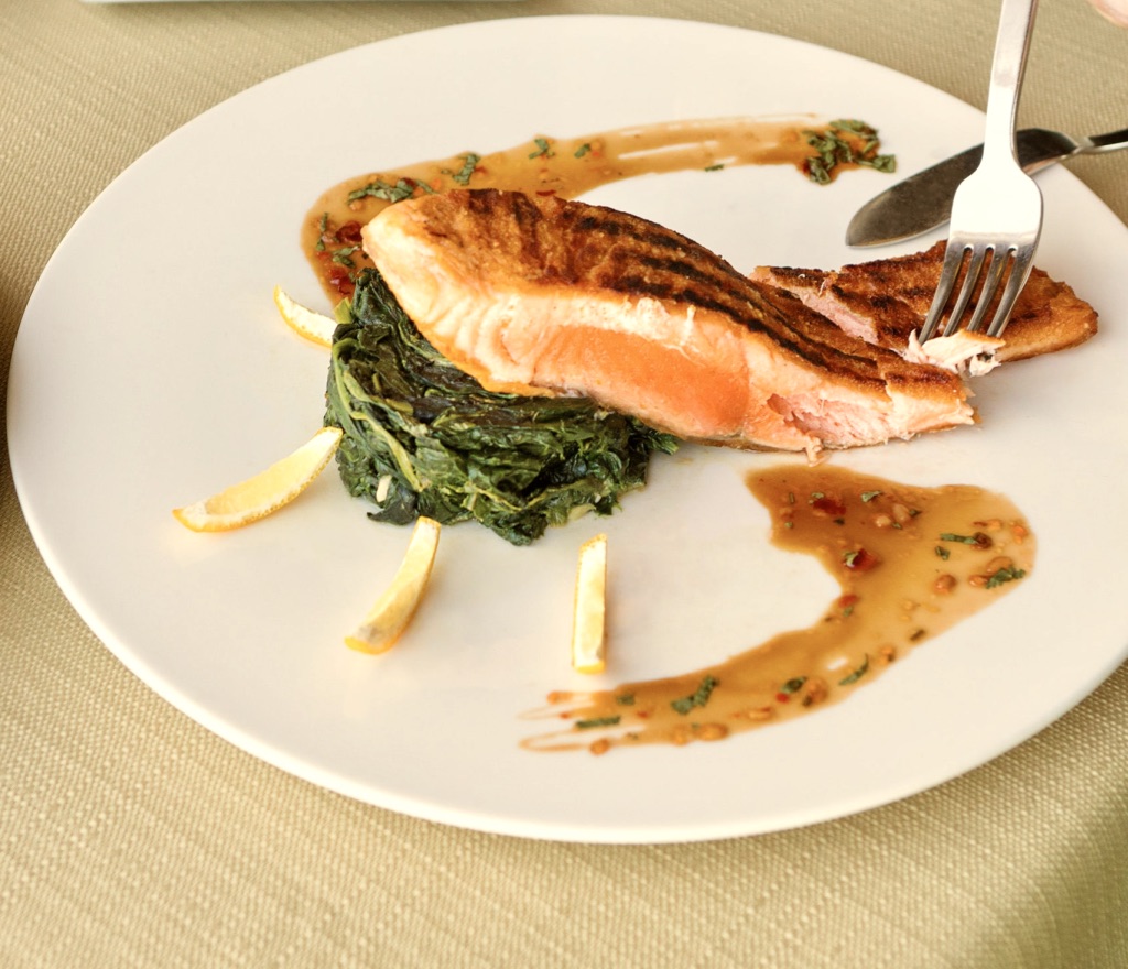 Norwegian fresh fish dish on white plate with sauce and vegetables