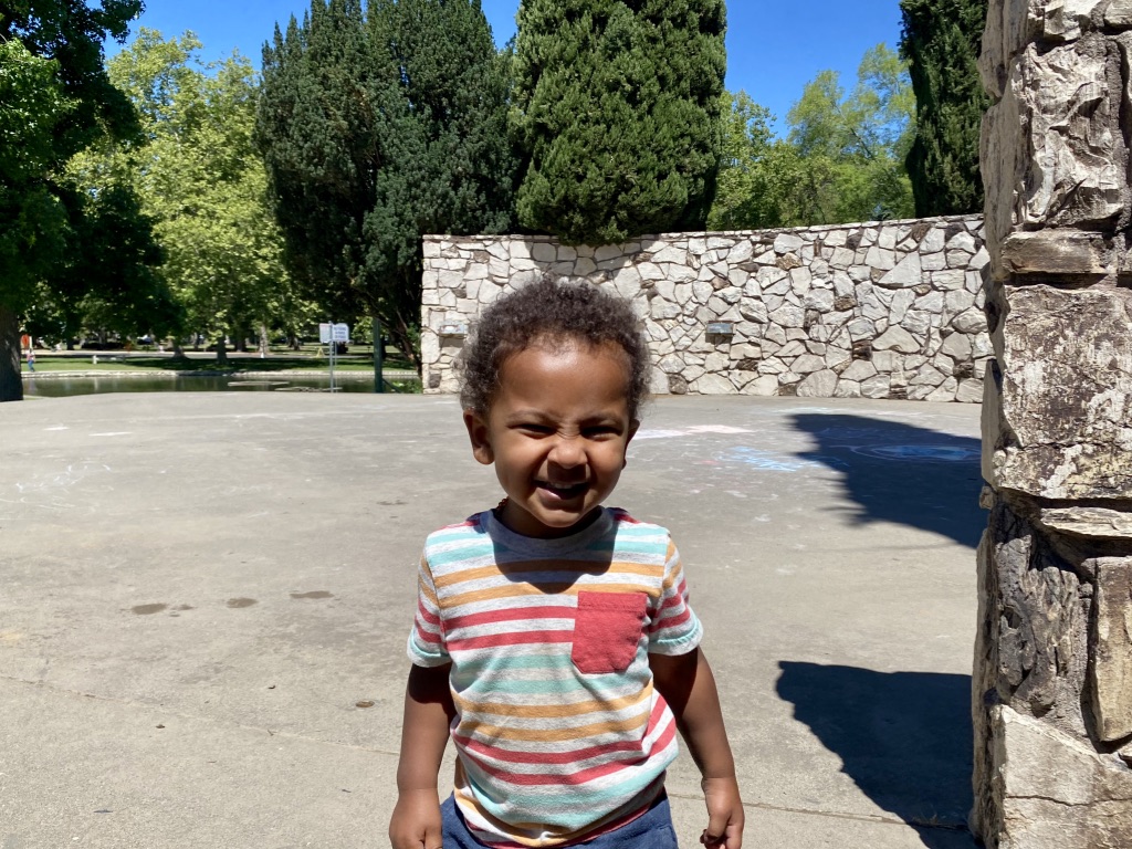 Toddler having fun playing at an outdoor theater 