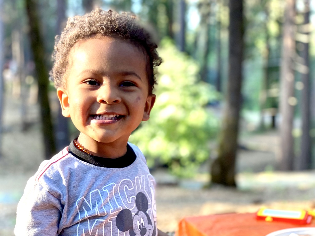 happy toddler outside with a smile