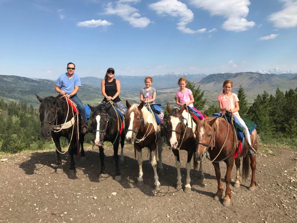 Family riding horses in Yellowstone National Park