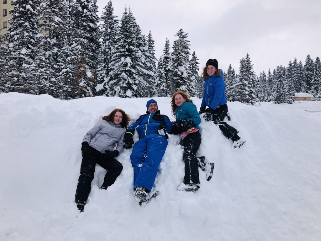 Family playing in the snow Banff Canada