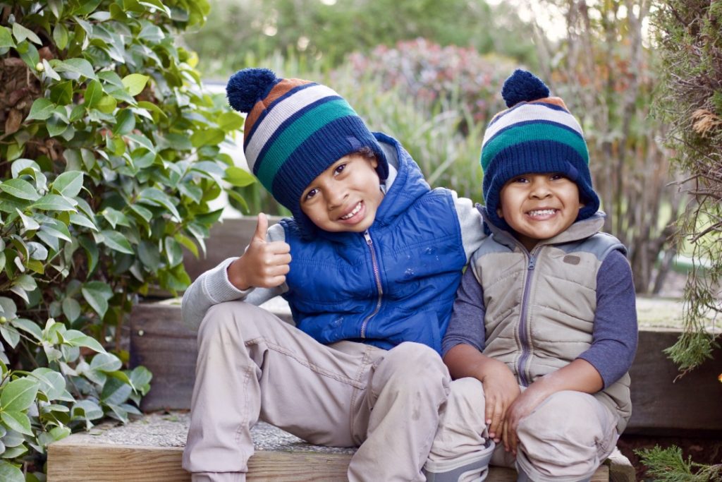 to kids in winter hats encouraging outdoor play