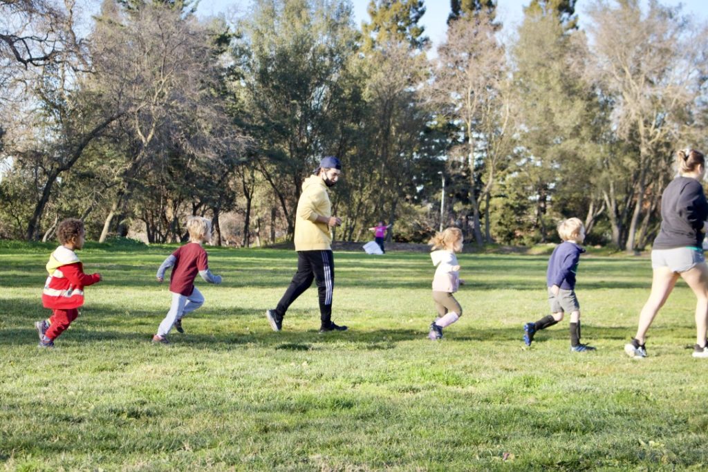 five kids playing outdoors while learning